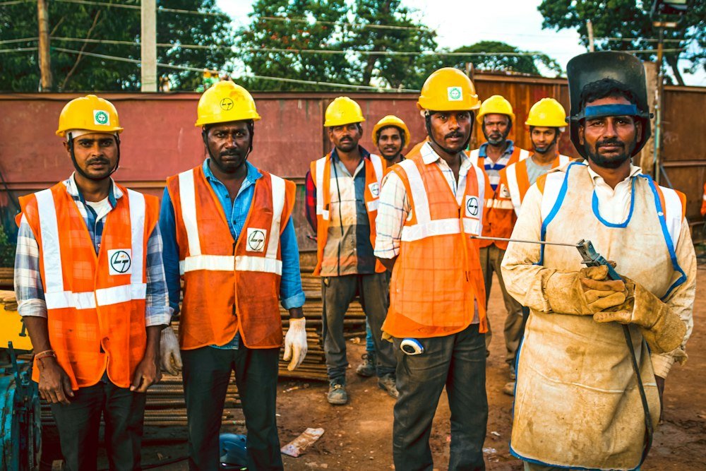 Two NorthPeak Roofing crew members in hard hats and safety vests on site